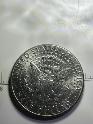 2000 Kennedy half dollar with off-center strike error showing misaligned design and blank planchet area